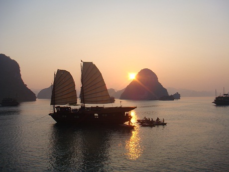 Floating boat in Ha Long Bay at sunset