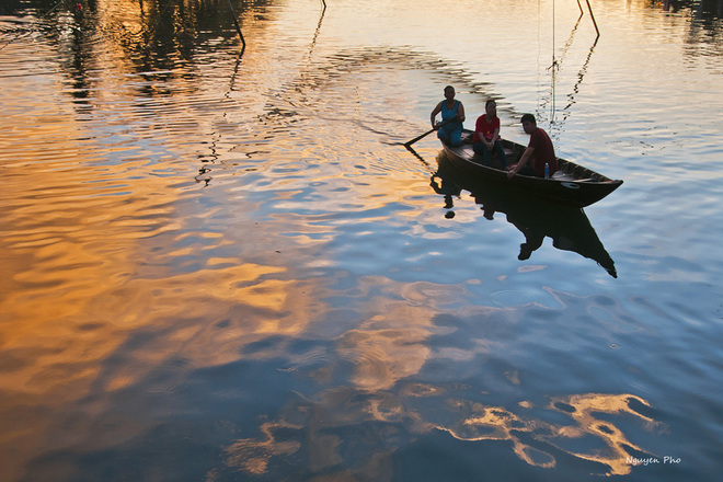 Sitting on the small boat, moving along the ancient town 